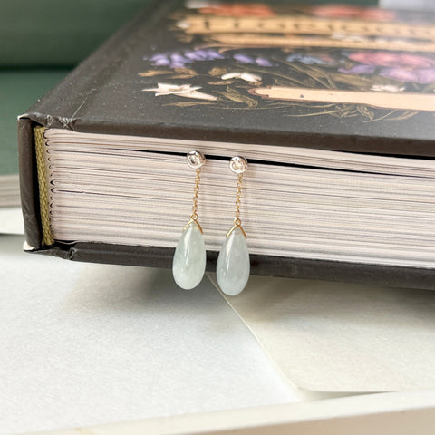 Teardrop earrings on a book with a floral design